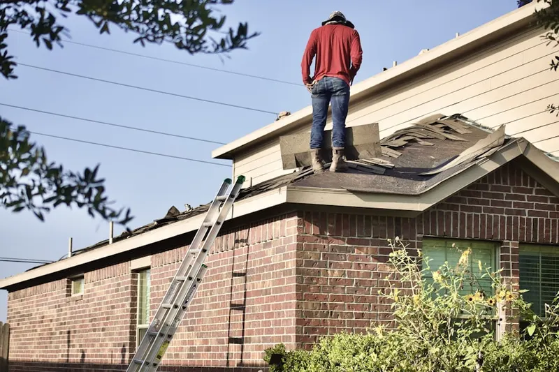 Professional roofer working on a residential roof in Pelican Hill